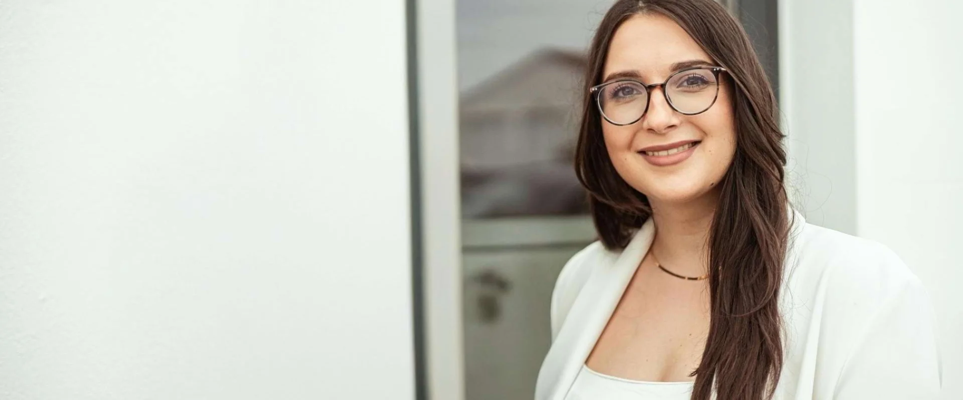 Melek Ali ist im Porträt zu sehen und blickt freundlich in die Kamera.