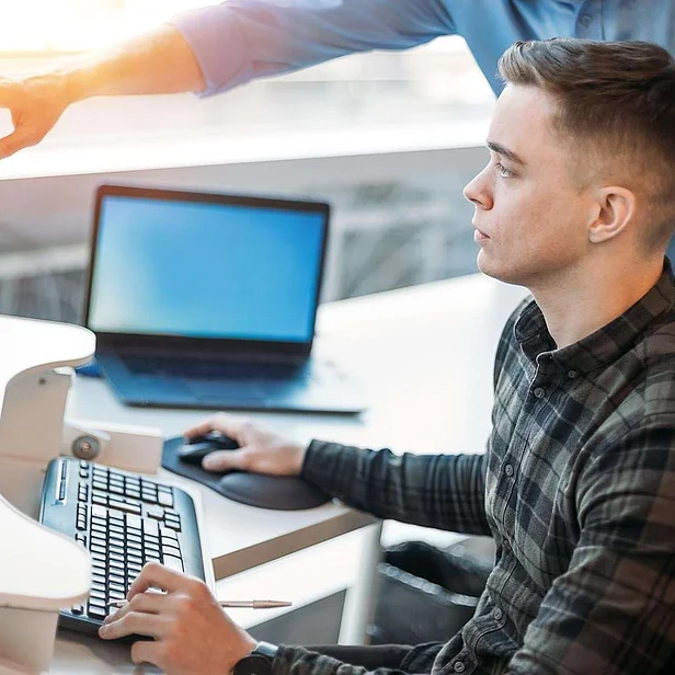 Auszubildender Fachinformatiker für Systemintegration arbeitet am Arbeitsplatz mit IT-Technik. Auszubildender Fachinformatiker für Systemintegration arbeitet am Arbeitsplatz mit IT-Technik.
